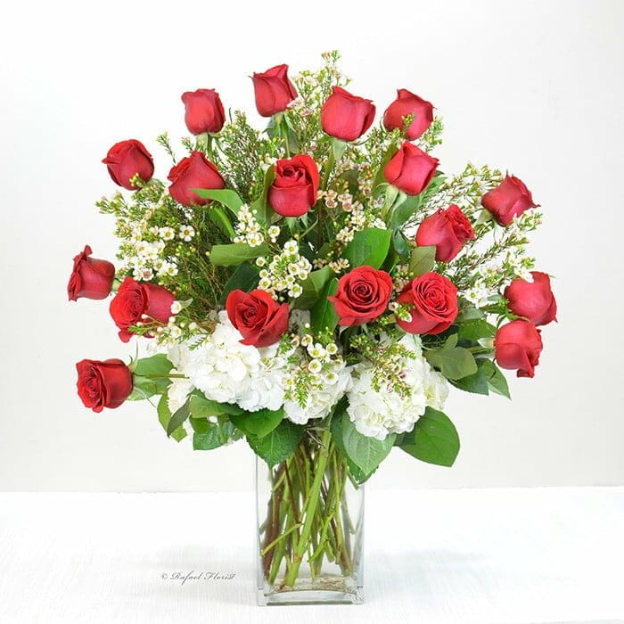 Classic design of dozen premium red rose and lush greenery