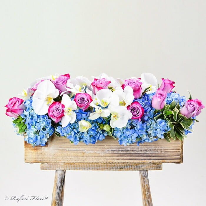 blue hydrangeas lavender roses and orchids centerpiece - Best Florist in Marin County