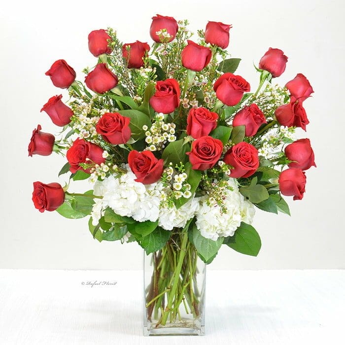 Classic design of dozen premium red rose and lush greenery